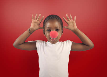 Little girl makes grimace with red noiseの写真素材