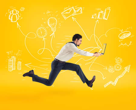 Fast business concept with businessman running with a laptop.