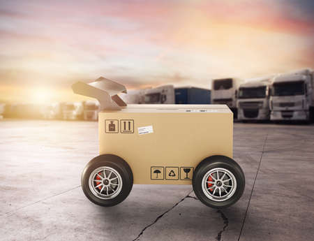 Priority Cardboard box with racing wheels like a car. Fast shipping by road.の写真素材