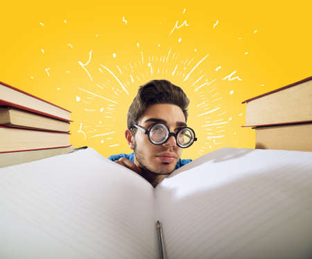 Exhausted student is studying hard on the deskの写真素材