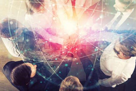 Group of young people make an agreement in the office. Double exposure with network effectsの写真素材