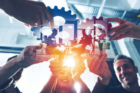 Business team connect pieces of gears. Teamwork, partnership and integration concept.の写真素材