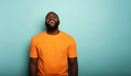 Joyful and happy guy over cyanの写真素材