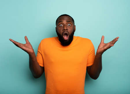 Amazed and shocked expression of a boy over cyan