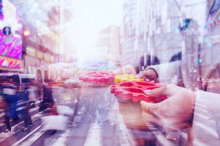Business team connect pieces of gears. Teamwork, partnership and integration concept. double exposureの写真素材