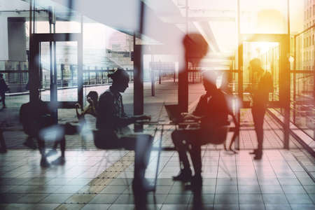 Background concept with business people silhouette working in the office near a window glass. Double...