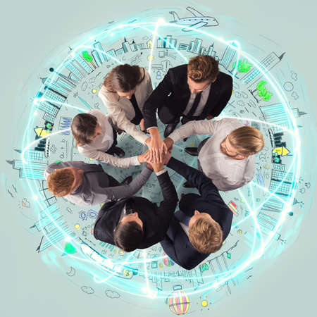 Handshaking business person above a round and ccreative drawing. concept of teamwork and partnership.の写真素材
