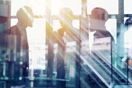 Businessmen that work together in office. Concept of teamwork and partnership. double exposureの写真素材