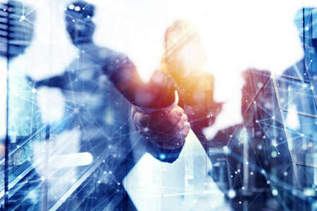Handshaking business person in office. concept of teamwork and partnership. Double exposureの写真素材