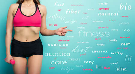 Gymnastic girl indicates something. concept of health and physical fitness . Cyan background with Most popular termsの写真素材