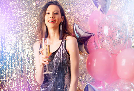 Girl drinks sparkling wine to celebrate the new year