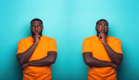 Black man with feelings of guilt is in doubt whit himselfの写真素材