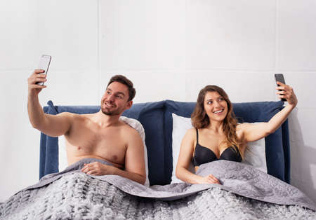 Both Girlfriend and boyfriends are chatting with others. Infidelity conceptの写真素材