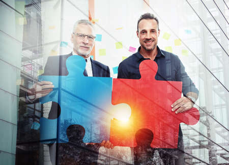 Partnership of business people. Concept of integration and startup with colored puzzle piecesの写真素材