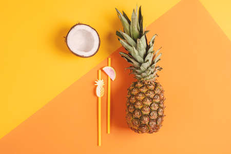 Composition of coconut and pineapple fruit on yellow background
