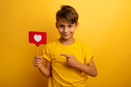 Child is happy because receives hearts on social networkの写真素材