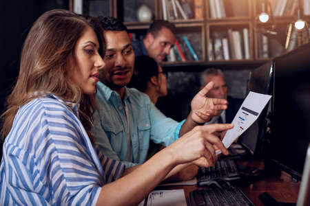 Business people that work together in office with a project plan. Concept of teamwork and partnershipの写真素材