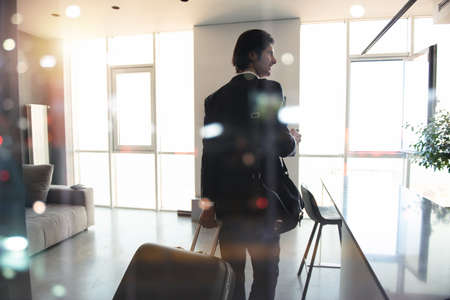 Businessman at the phone ready to travel.の写真素材