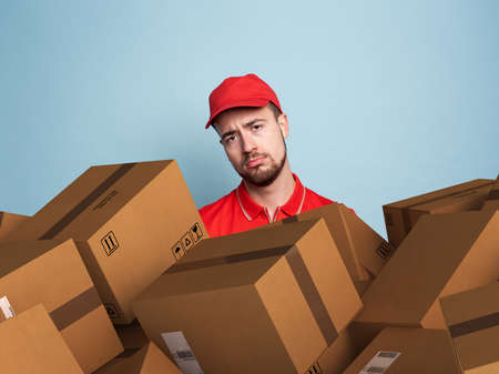 Courier is confused due to a lot of packages to deliver.の写真素材