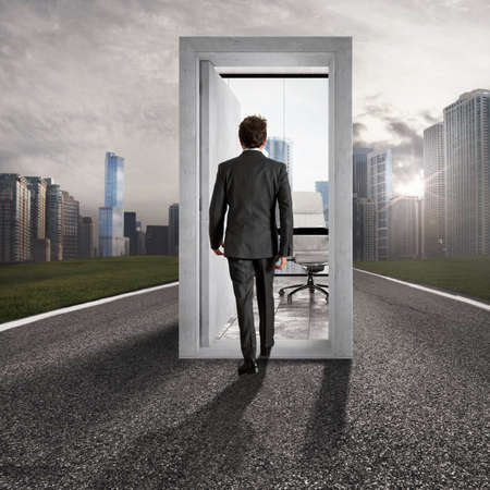 Businessman entering an open door in the center of a road leading to career success