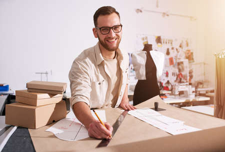 Seamstress works to new clothes ordered by internet client