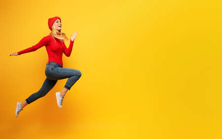 Girl runs fast. concept of energy and vitality.yellow background