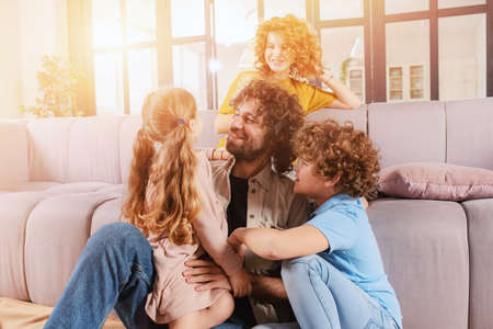 Happy family play together at home on sofa. concept of union, love, affection