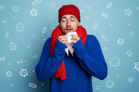 Boy caught a cold and is surrounded by viruses and bacteria.の写真素材