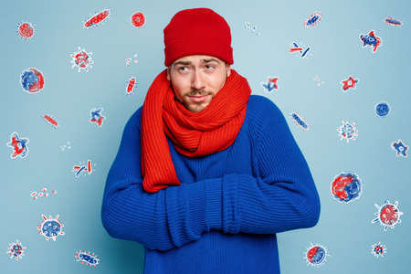 Boy caught a cold and is surrounded by viruses and bacteria.の写真素材