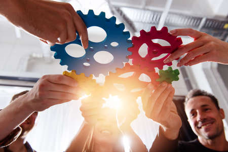 Business team connect pieces of gears.