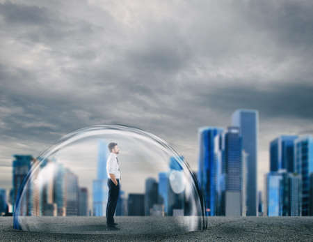 Businessman safely inside a shield dome. Protection and safety concept