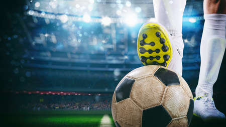 Close up of a soccer striker ready to kicks the ball at the stadiumの写真素材