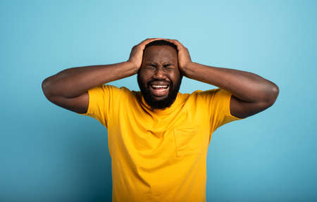 Sad and desperate expression of a boy who is scared to catch the covid-19 coronavirus. Cyan...