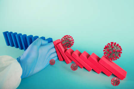 Concept of covid19 coronavirus pandemic with falling chain like a domino game. Contagion and infection progression stopped by a hand of a doctor. Cyan backgroundの写真素材