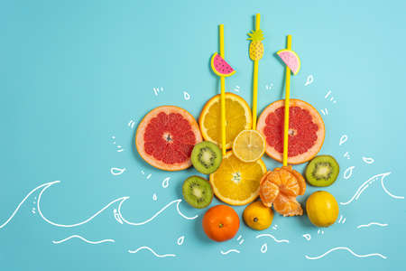 Composition of orange and lemon on yellow background