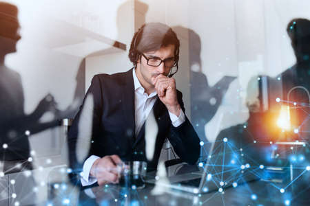 Businessman works from remote at house with a laptop due to coronavirus quarantine.の写真素材