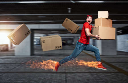 Courier with fiery feet has a lot of boxes to delivery.の写真素材