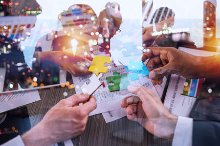 Teamwork of partners. Concept of integration and startup with puzzle piecesの写真素材