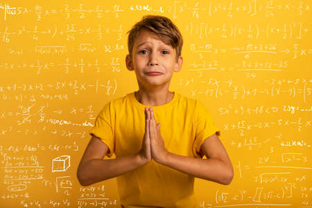 Child is pleading because he does not want to study. Yellow background