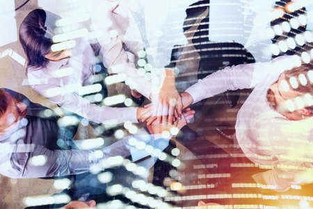 Business people putting their hands together. Concept of teamwork and partnership