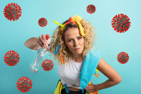 Funny housewife cleans and disinfects to keep germs, viruses and bacteria away.の写真素材