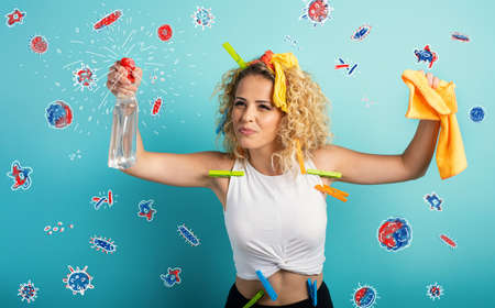 Funny housewife cleans and disinfects to keep germs, viruses and bacteria away.の写真素材