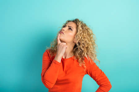 Confused woman have to choose something. concept of options, confusion, decision.の写真素材