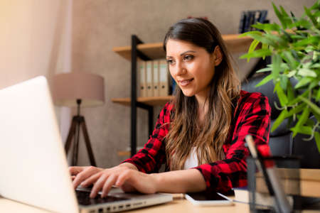 Girl teleworker works at home with a laptop