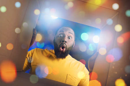 Surprised boy receives Christmas gift. happy and surprised expression.の写真素材