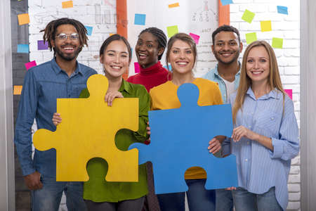 Teamwork of partners. Concept of integration and startup with puzzle piecesの写真素材