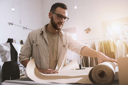 Seamstress works to new clothes ordered by internet client