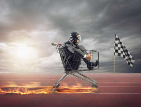 Businessman runs fast driving a cart on fire during a competition