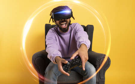 Man with VR glasses play with a virtual videogame.