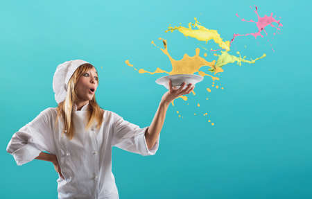 Happy chef cooks a new sweet creative recipeの写真素材